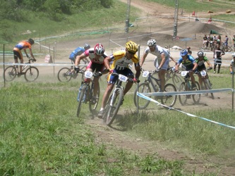 Racers charge around mountain bike short course at Deer Valley.