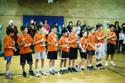 Team lined-up with trophies.